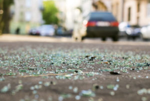 broken glass on the street from the result of a car accident