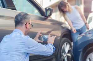 Man photographing car accident