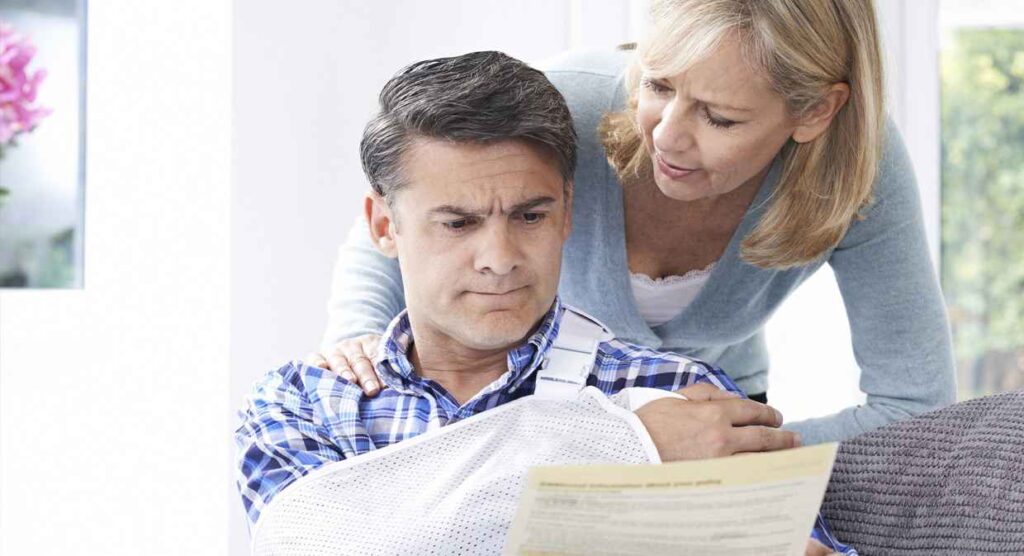 man injured in car accident reviewing papework